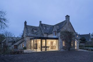 glass box extension to a listed cottage