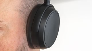 Close-up view of left ear cup on Sennheiser Momentum 4 Wireless.