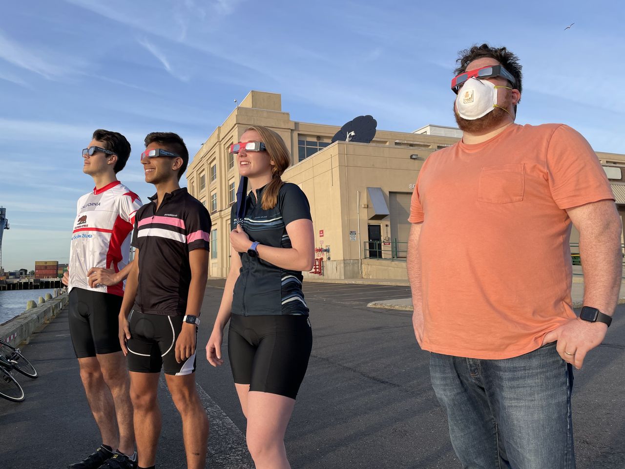 Spectators observe a partial solar eclipse from Black Falcon Cruise Ship Terminal in Boston, Massachusetts on June 10, 2021.