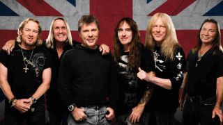 Iron Maiden posing for a photograph in front of a Union Jack backdrop