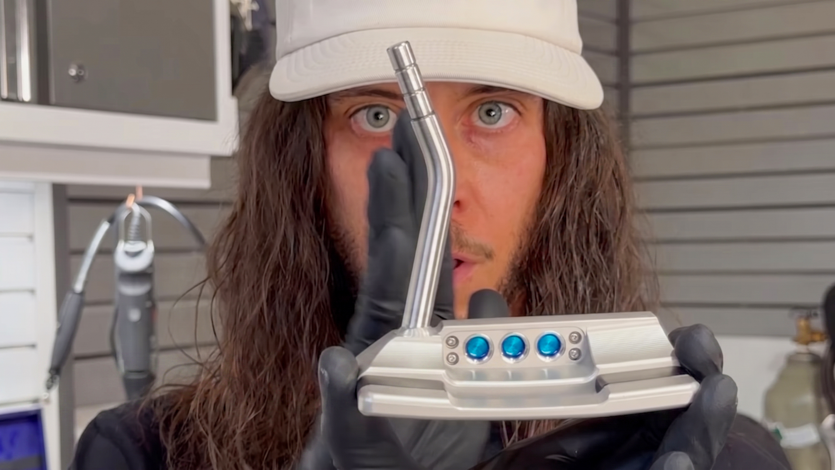 Photo of Rush Kane looking at a putter