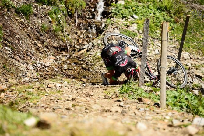 A rider takes a tumble during stage 3 of the Bike Four Peaks