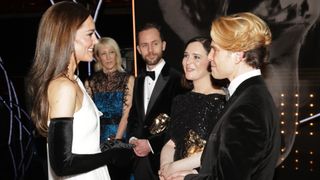 Catherine, Princess of Wales, speaks to (L-R) Cara Speller, Peter Baynton, Hannah Minghella and Daniel Marc Dreifuss after the EE BAFTA Film Awards 2023
