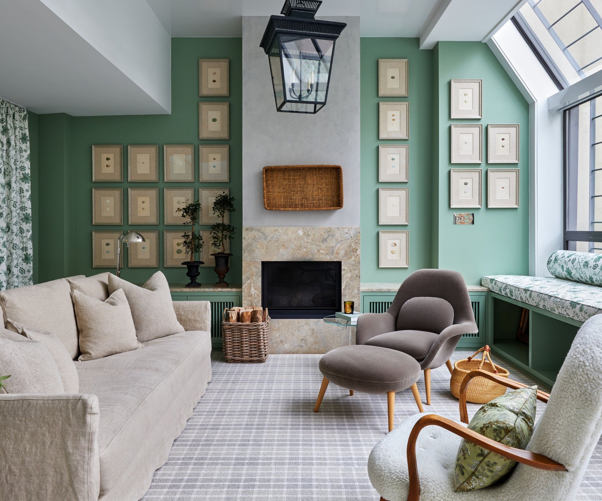 living room with pistachio green gallery wall, gray carpet, neutral sofa and armchairs, and white trim