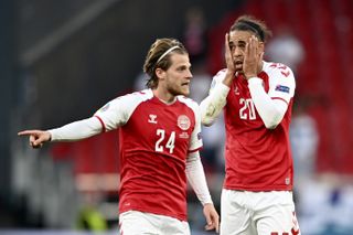 Denmark’s Yussuf Poulsen, right, and Mathias Jensen react after seeing Eriksen collapse