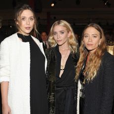 Ashley, Mary-Kate, and Elizabeth Olsen posing together at a LACMA event.