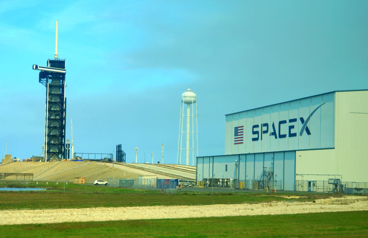 SpaceX building with a launch pad behind it