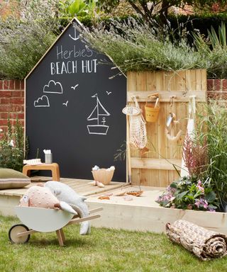 kids garden area with sandpit and chalkboard