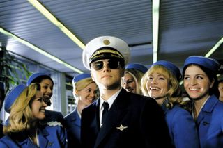 leonardo dicaprio dressed as a pilot with a group of flight attendants in the movie catch me if you can