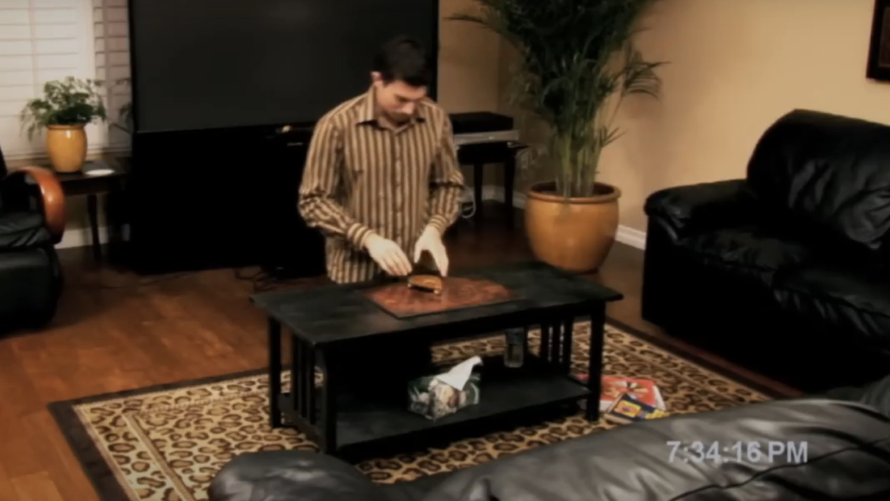 Micah Sloat using a Ouija board in Paranormal Activity