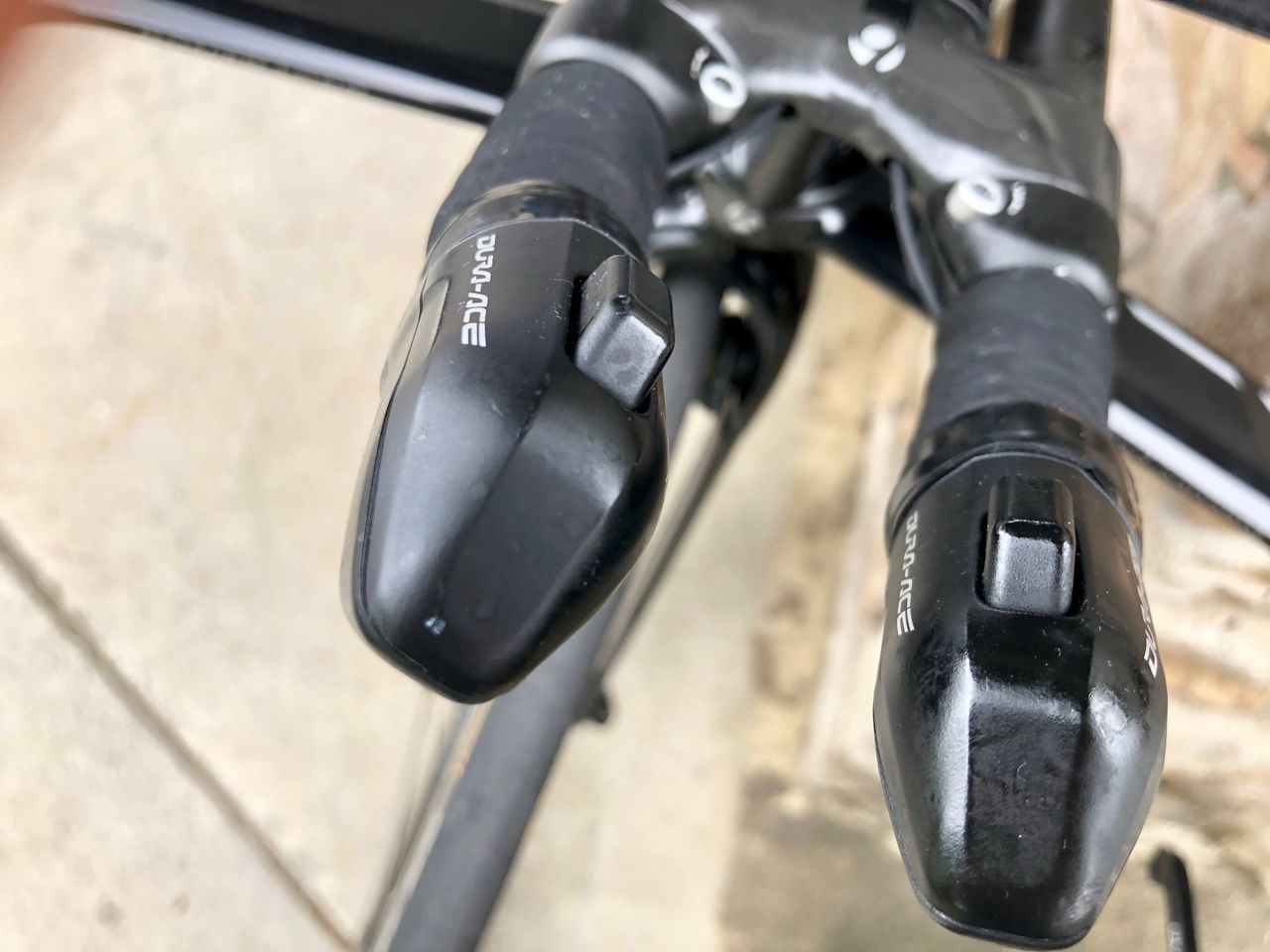 Shimano has single- and dual-button extension shifters. Usually, single buttons are configured to work the rear derailleur, with one shifting up and the other shifting down