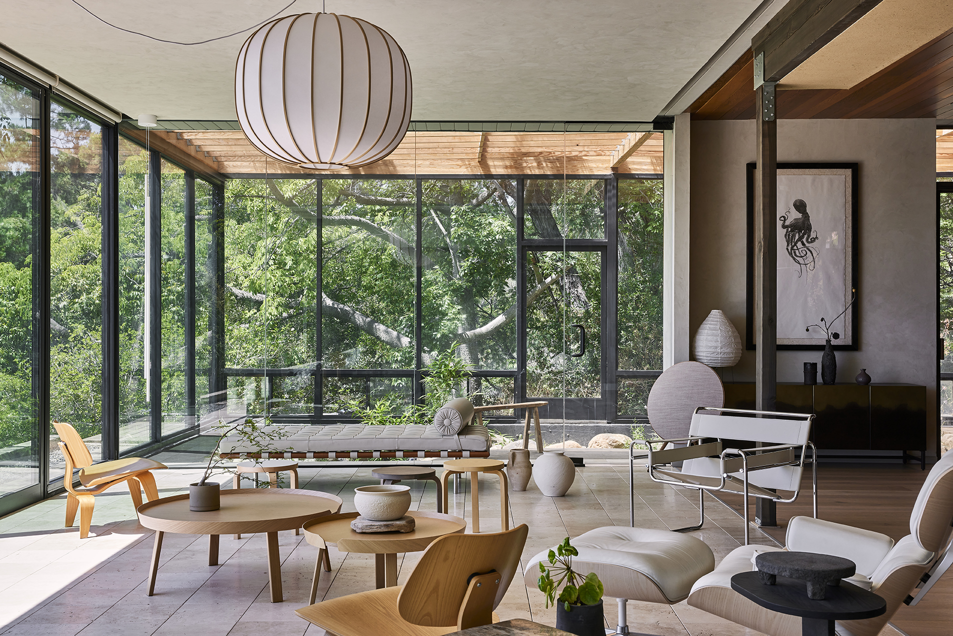 The home's primary living space opens seamlessly to the surrounding canopy, balancing artisanal details, refined furnishings, and a profound connection to nature.