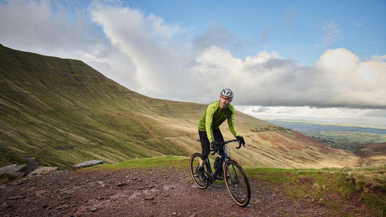 Male cyclist riding a budget gravel bike.