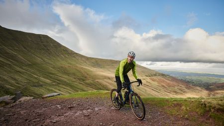 Male cyclist riding a budget gravel bike.