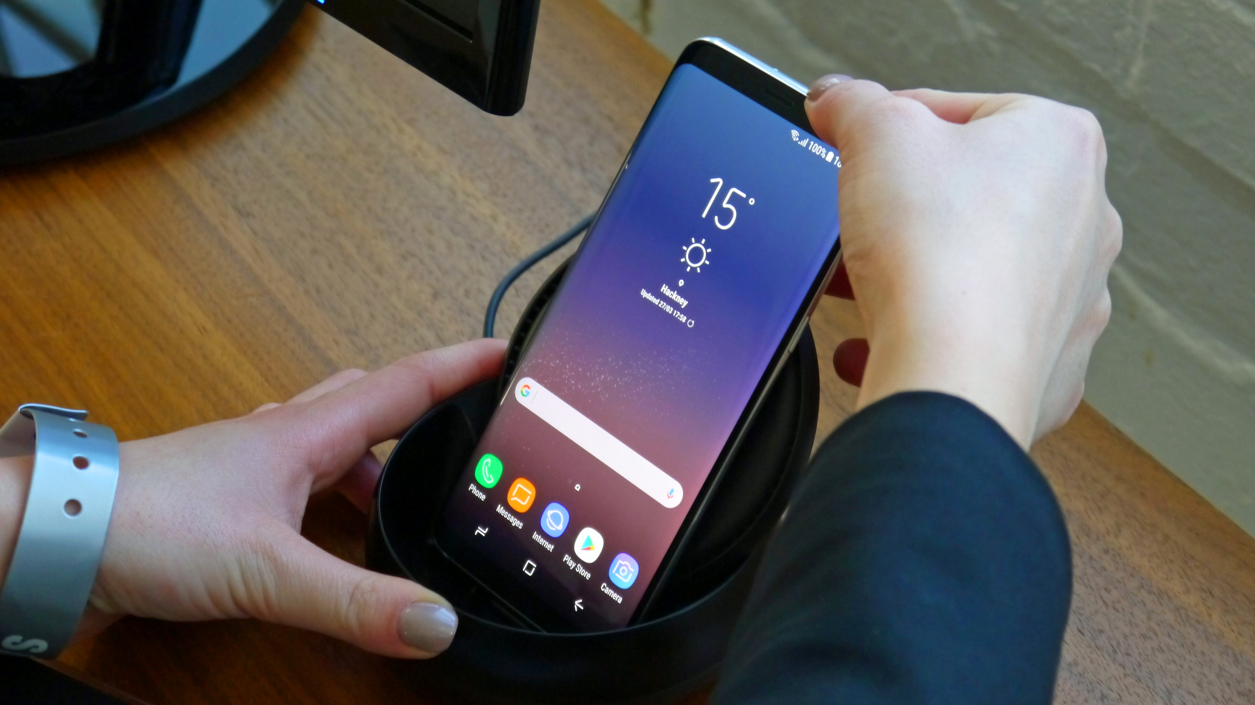 Samsung Galaxy S8 showing home screen in hand