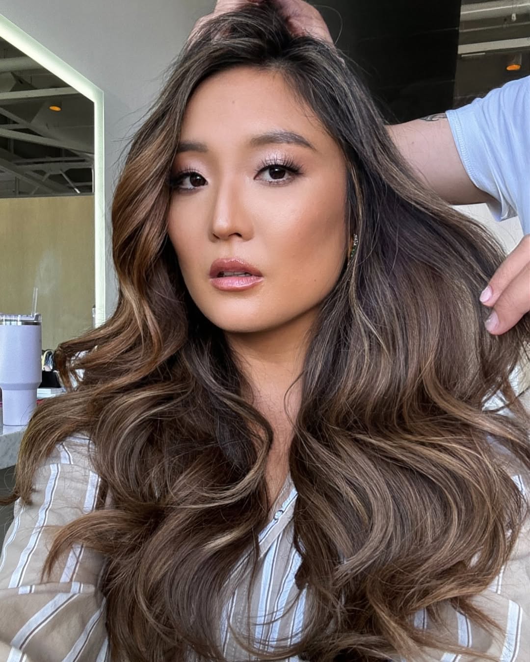 Ashley Park with ash brown hair by Clayton Hawkins.
