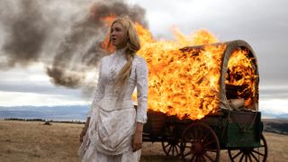 Isabel May as Elsa in 1883 in front of a burning wagon