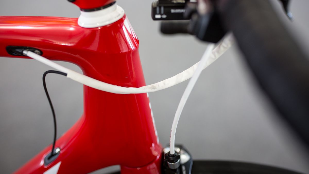 The brake and gear cables are kept together with white shrink wrap
