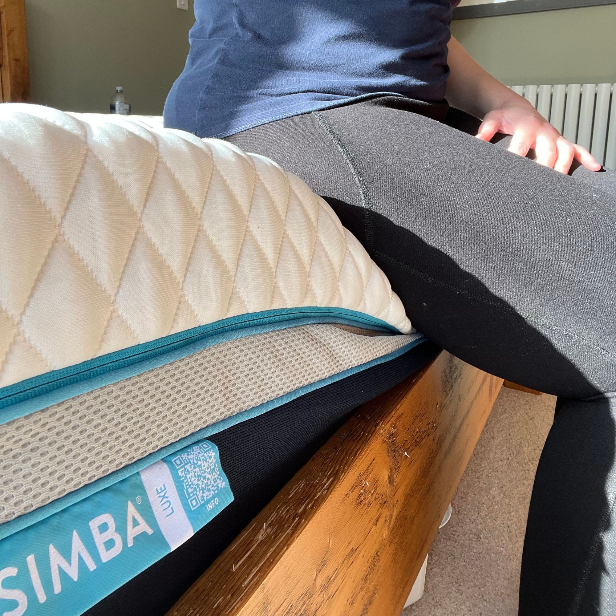 person sitting on the edge of the Simba Hybrid Luxe Mattress