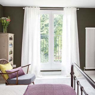 bedroom with dark green walls and view towards window