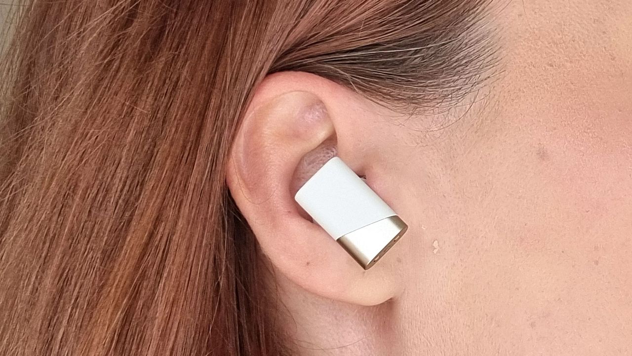 a picture of our reviewer wearing the Status Pro X earbuds