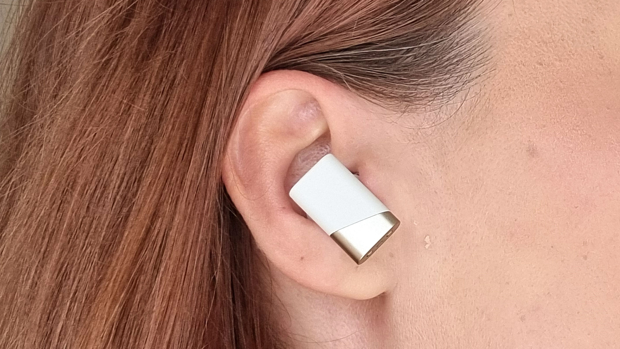 a picture of our reviewer wearing the Status Pro X earbuds