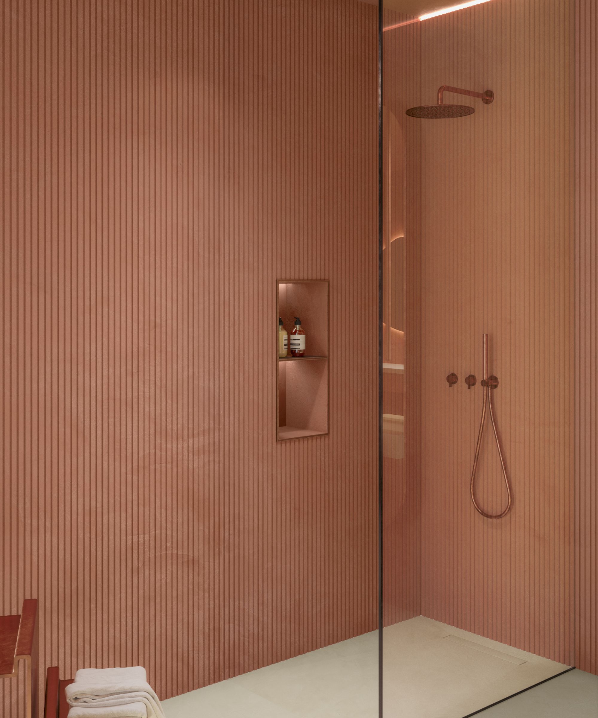 Walk in shower with pink slatted wet wall panels and a small backlit shower niche