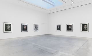 Portraits on walls of white gallery