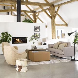 modern open plan living room space in farmhouse, beams, fireplace, natural scheme