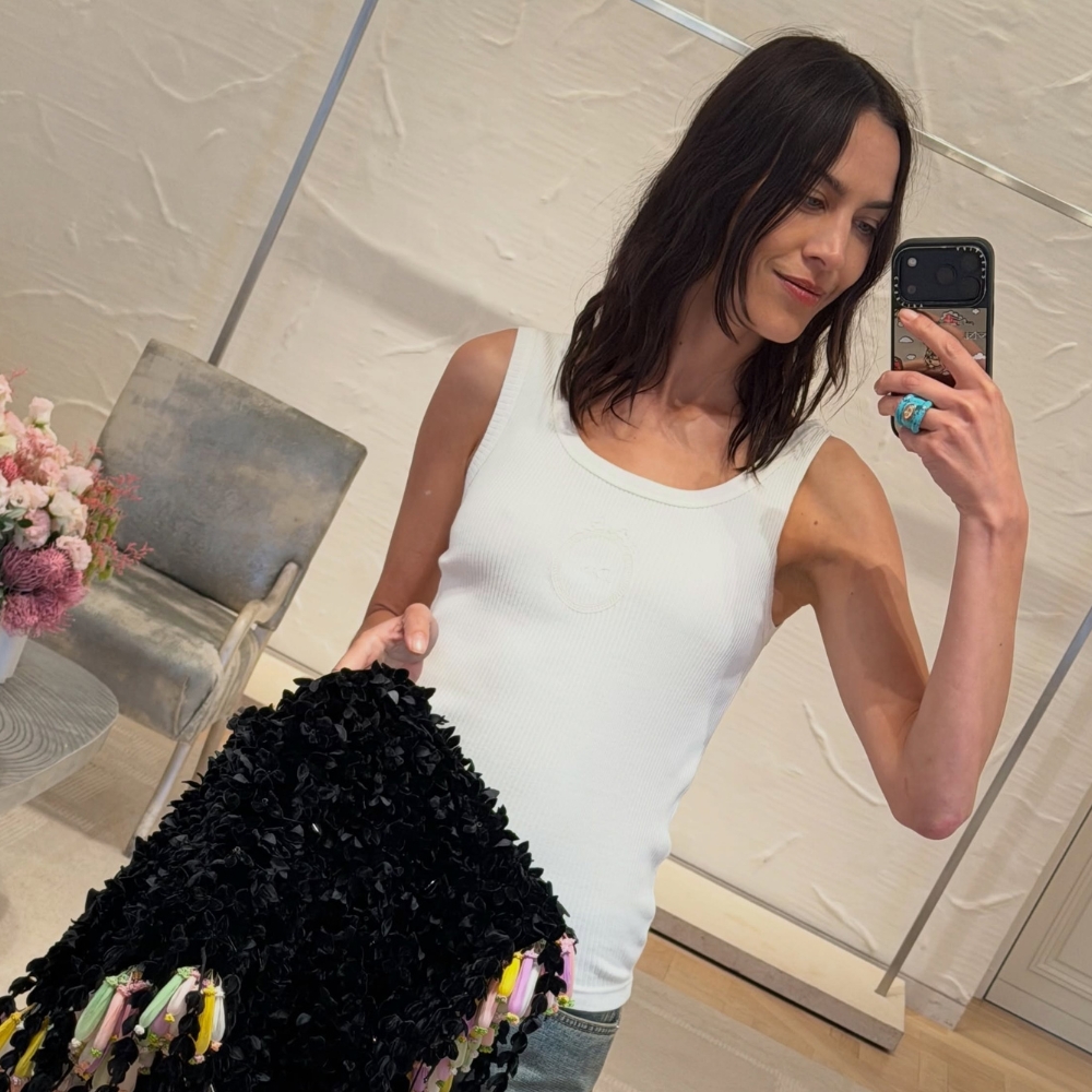 Alexa Chung wears Dior denim heels with jeans and a white tank top.