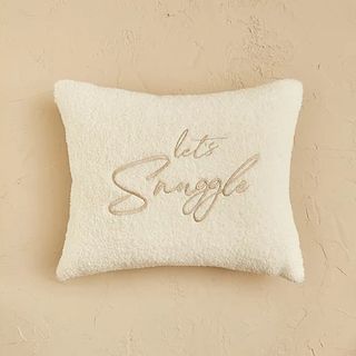 Cream slogan cushion with the words 'Let's snuggle' printed