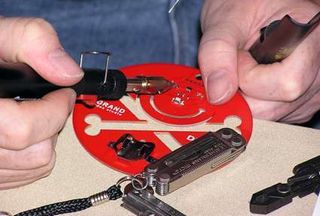 Attendees furiously try to hack the badge. Photo courtesy of Robert McLaughlin, InfoSec News.