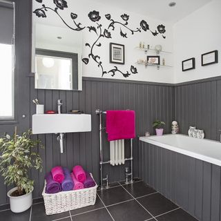 bathroom with grey bathtub and white wall