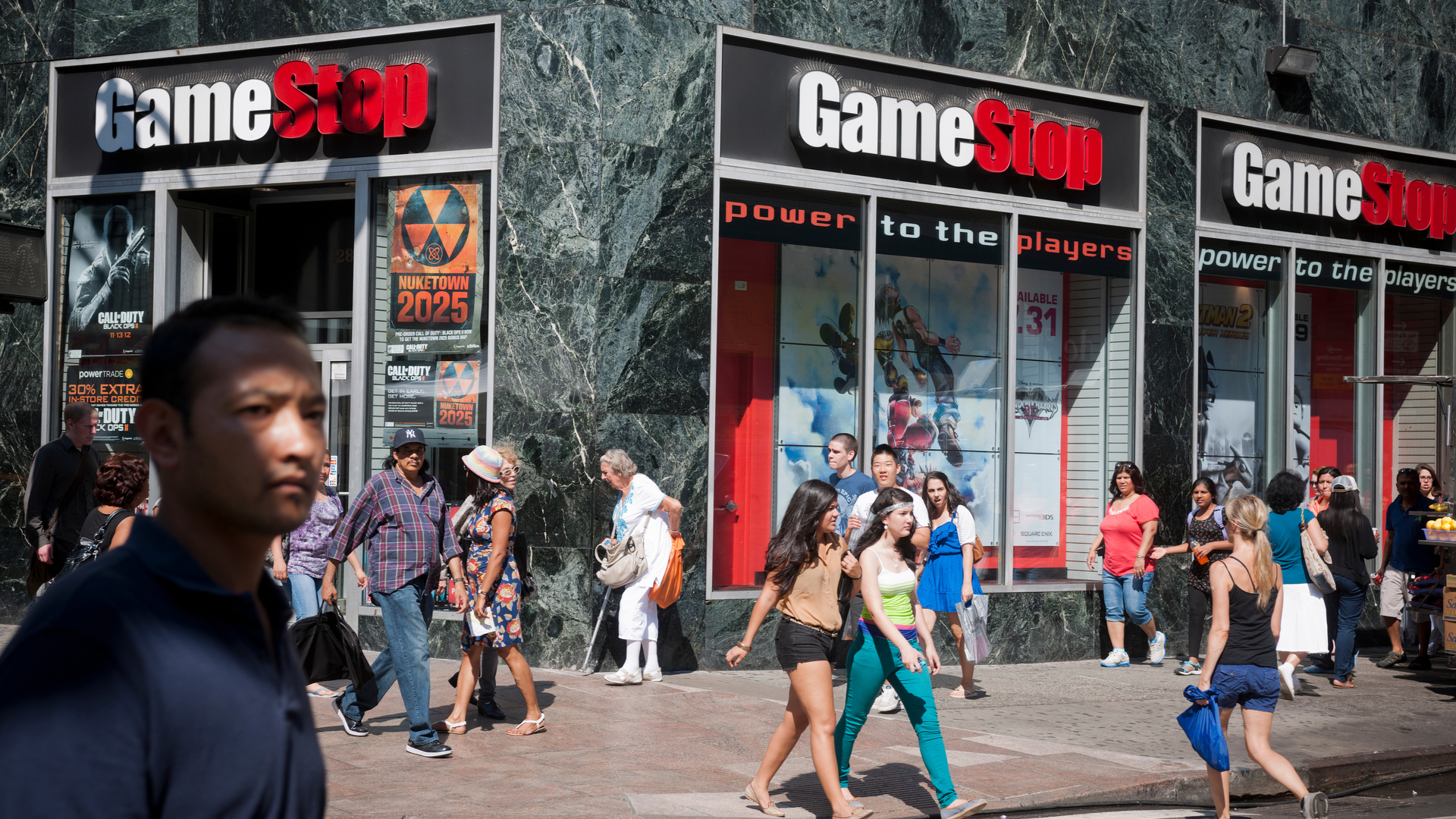 GameStop in store with people walking