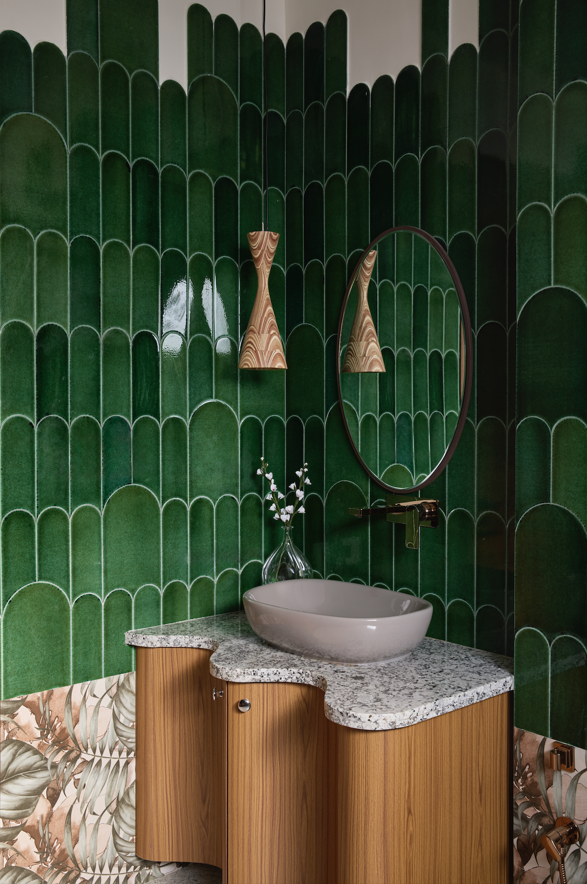 A bathroom with green scallop tiles