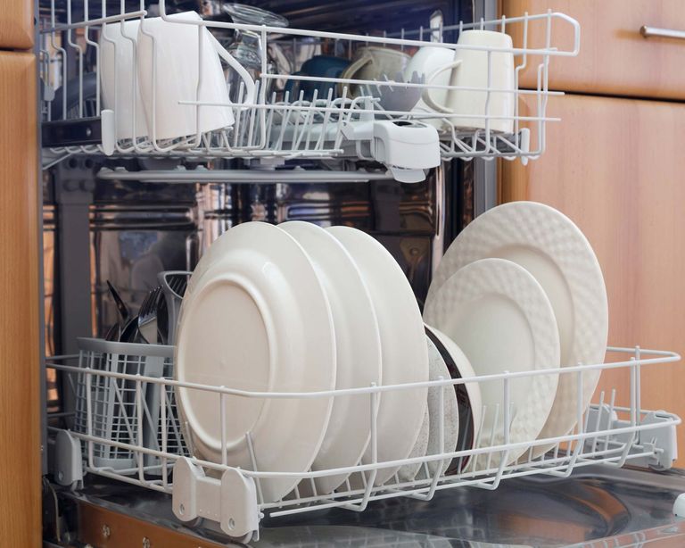 dishwasher ready to be unloaded of white plates