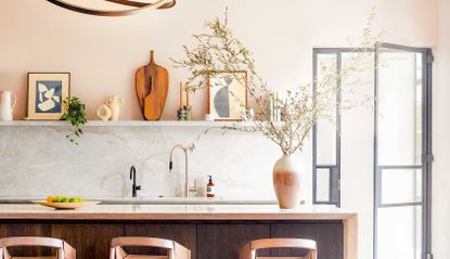 a kitchen with light pink painted walls