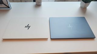 white and grey laptops on table