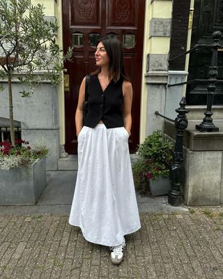 @francescasaffari wearing Sambas with a white skirt and vest.