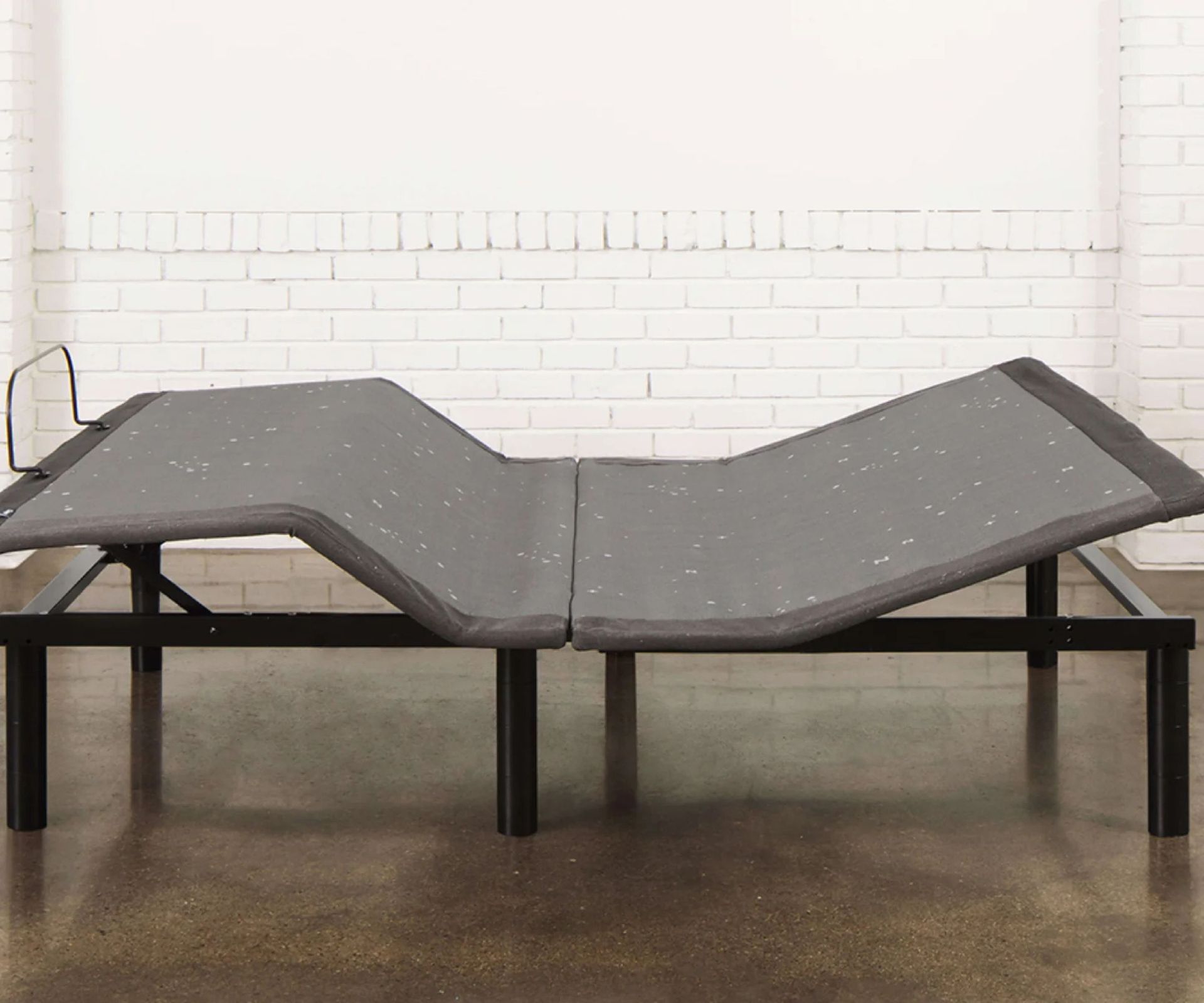 Casper Adjustable Base on a wooden floor against a white wall.