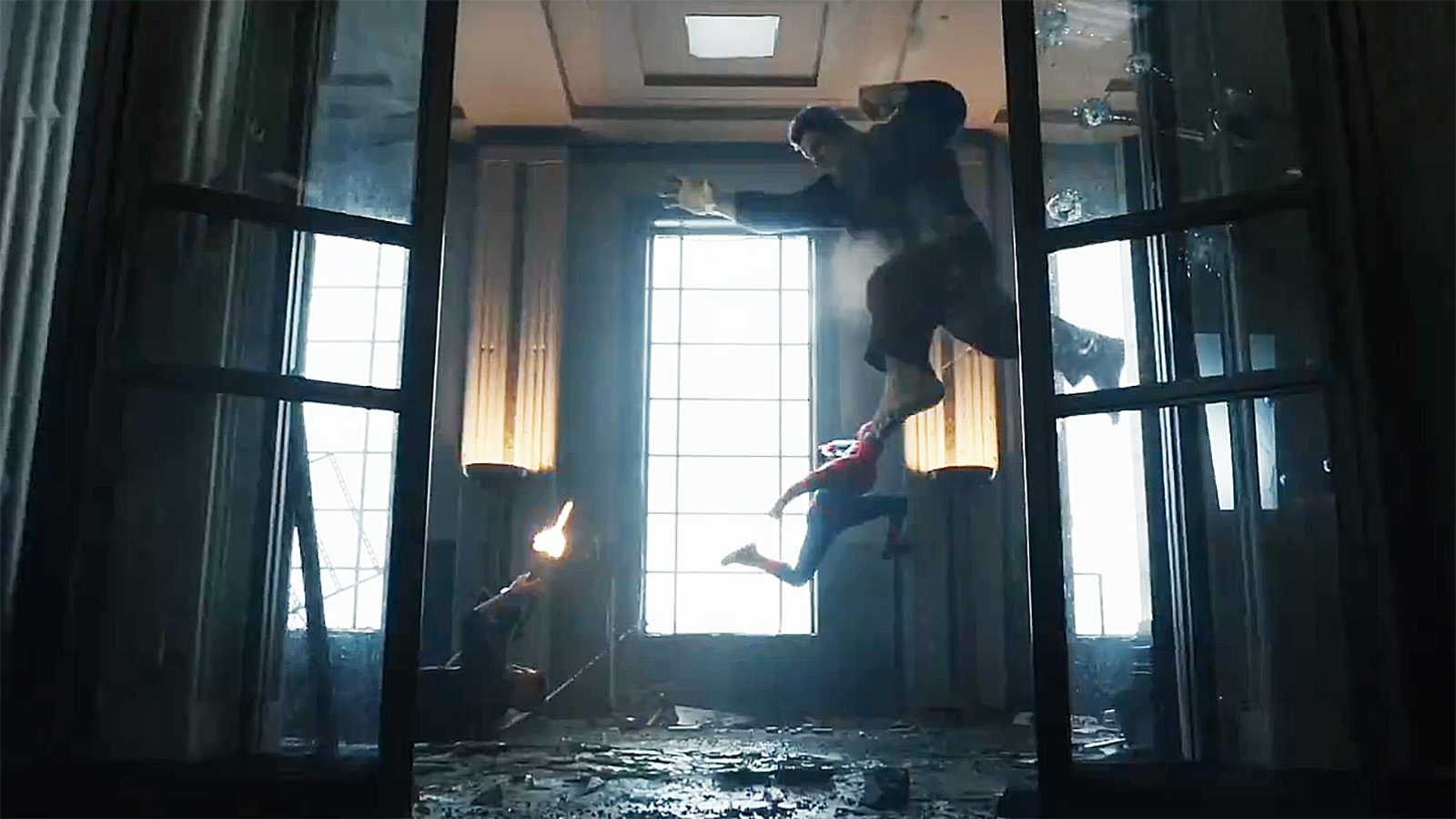 The Punisher lying on the floor as he fires a shot at an airborne Hulk, who Spider-Man is leaping at, in Spider-Man: Brand New Day
