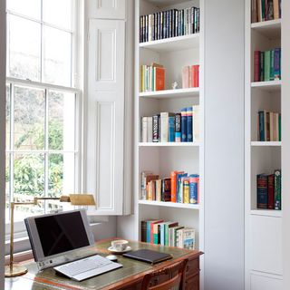 Home office with white walls and books