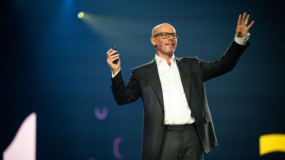 Oracle NetSuite executive vice president Evan Goldberg, delivering a keynote address with his hands raised 