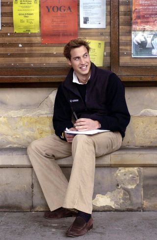 Prince William sits on a stone bench in St Salvator's Quad at St Andrews University where he is a student.