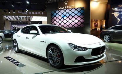 White Maserati car on a display stand