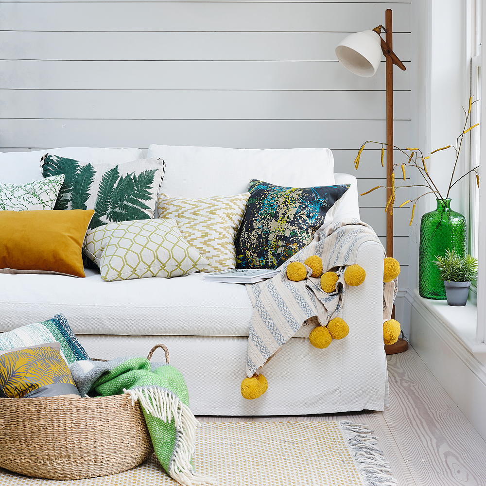 white living room with sofa and basket