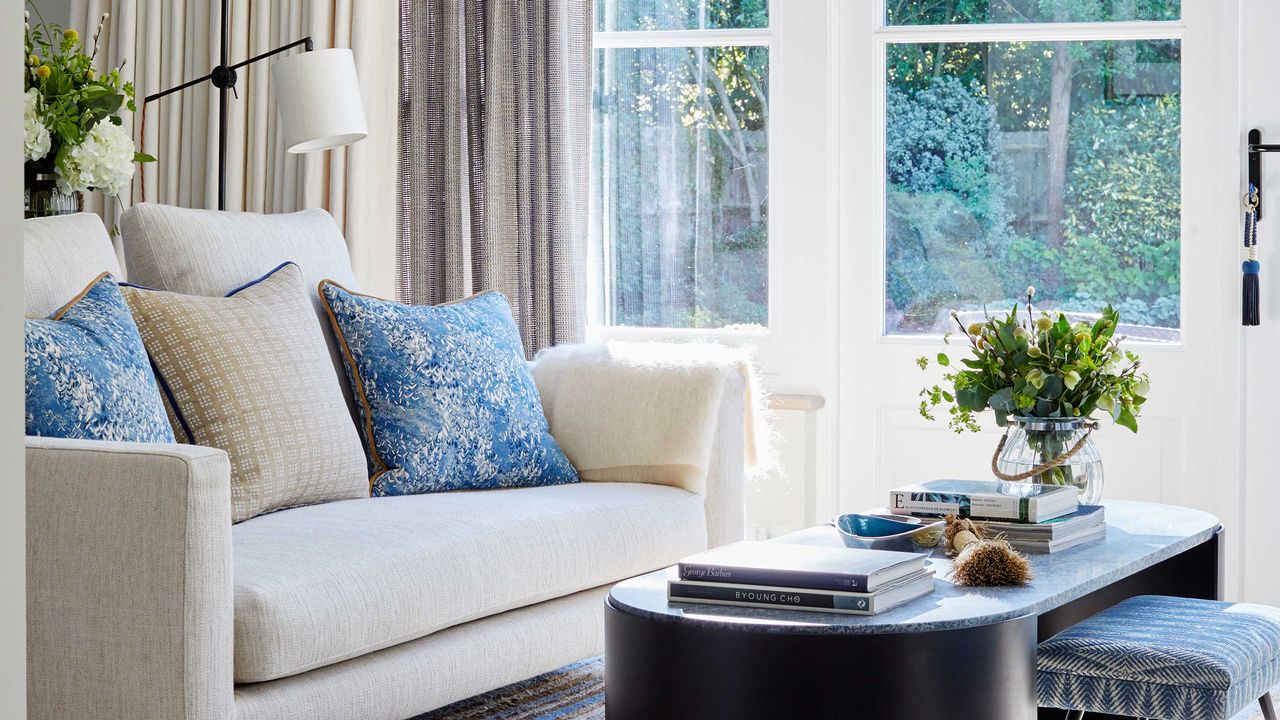 living room with cream couch and coffee table