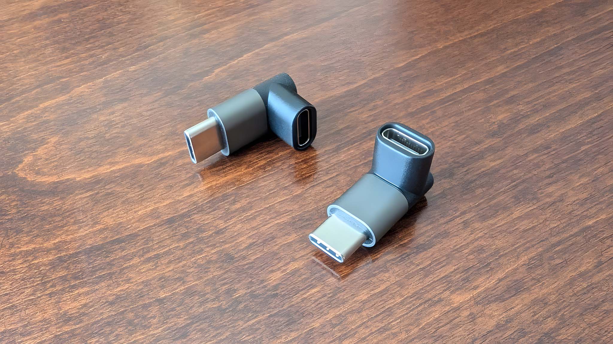 Two JSAUX USB-C right-angle adapters on table. 