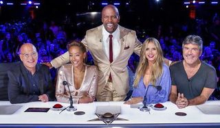 America's Got Talent: The Champions Terry Crews smiles as he stands behind the judges