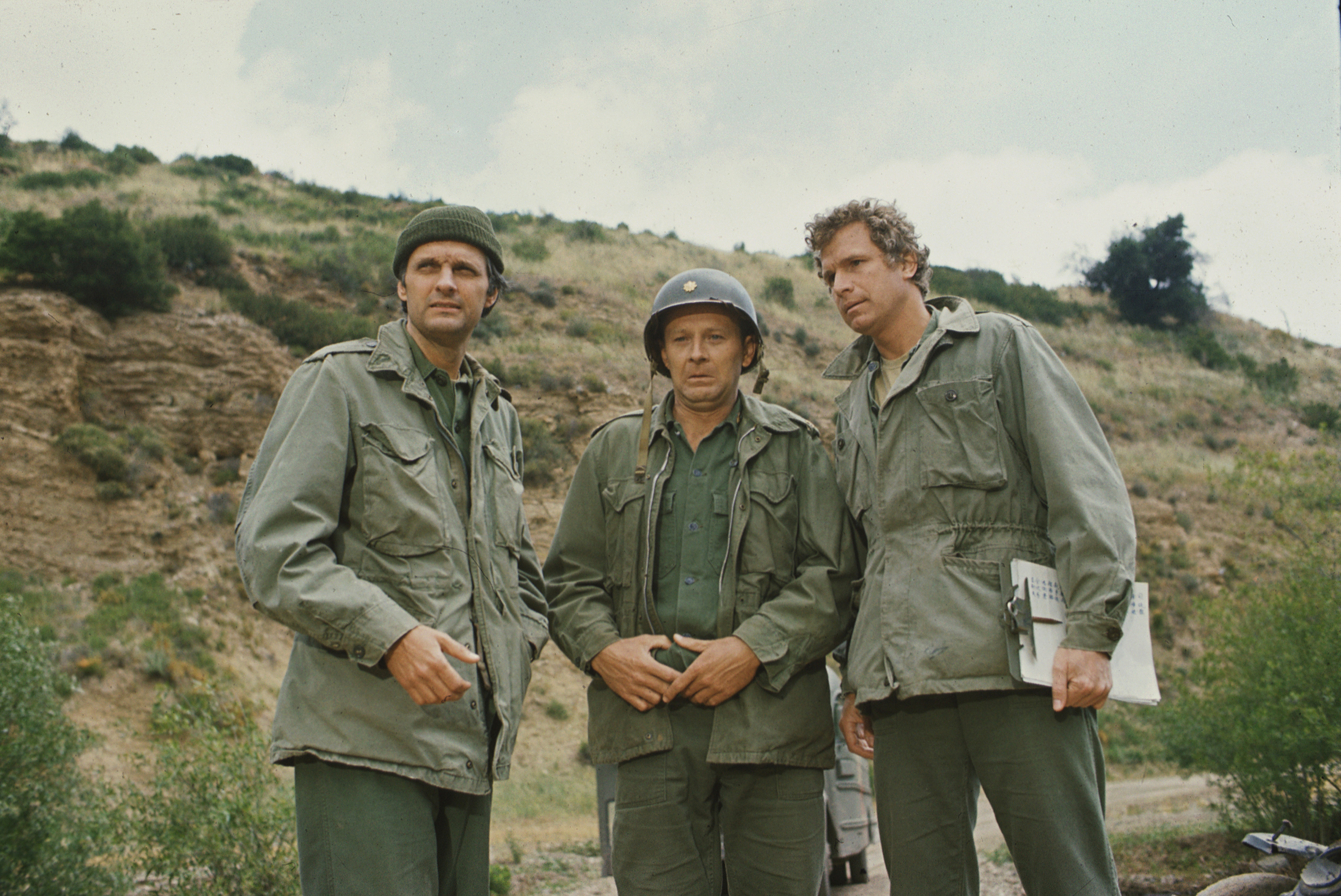 From left, American actors Alan Alda, as Captain Benjamin Hawkeye Pierce, Larry Linville (1939 - 2000), as Major Frank Burns, and Wayne Rogers, as Captain Trapper John McIntyre, in a scene from an episode of the television series 'MASH,' California, 1972.